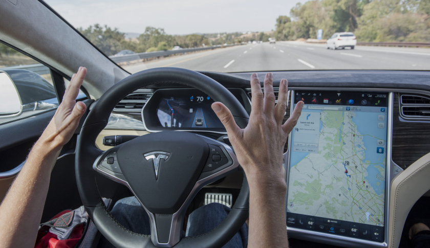 A member of the media test drives a Tesla Motors Inc. Model S car equipped with Autopilot in Palo Alto, California, U.S., on Wednesday, Oct. 14, 2015. Tesla Motors Inc. will begin rolling out the first version of its highly anticipated "autopilot" features to owners of its all-electric Model S sedan Thursday. Autopilot is a step toward the vision of autonomous or self-driving cars, and includes features like automatic lane changing and the ability of the Model S to parallel park for you. Photographer: David Paul Morris/Bloomberg via Getty Images